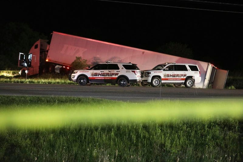 Livingston County Sheriff's work at the scene of cab of a tractor trailer after the driver was killed during a shootout with law enforcement officers