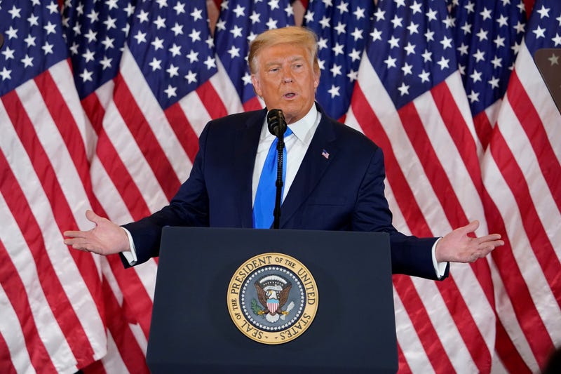 Trump in front of flags