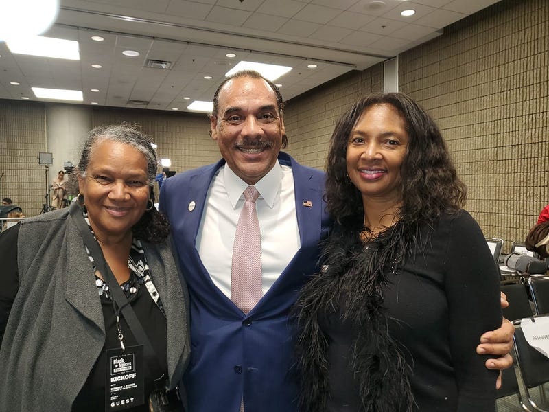 Loretta Grier Cudjoe of Macon is joined by fellow Trump supporters Bruce and Sharon Levell during the President's Atlanta visit Friday