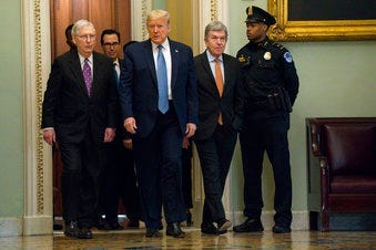 President Donald Trump walks with Senate Majority Leader Mitch McConnell of Ky., to a meeting with lawmakers on Capitol Hill, Tuesday, March 10, 2020, in Washington. (AP Photo/Evan Vucci)