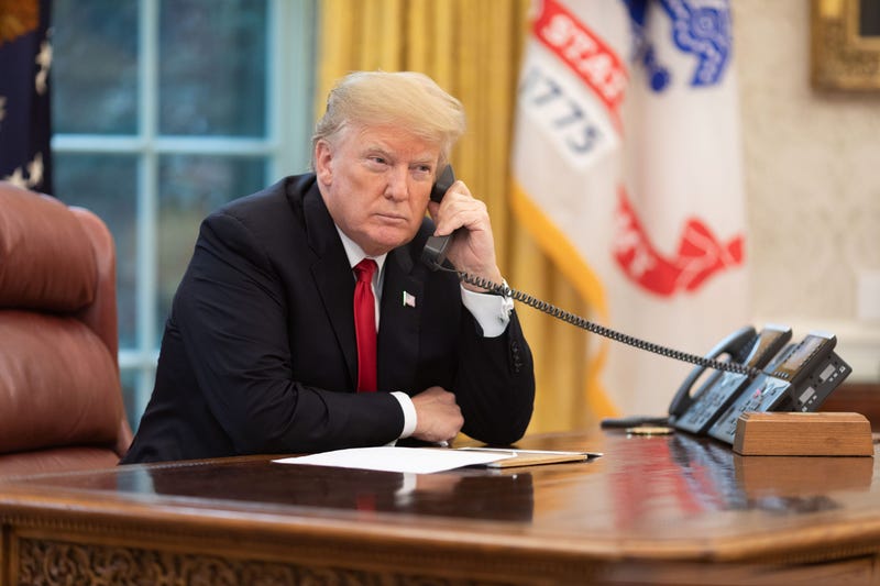 President Donald J. Trump speaks on the phone in the Oval Office 