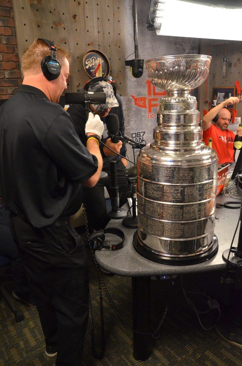 The Keeper of The Cup, Mike Bolt of the Hockey Hall of Fame, presents the Stanley Cup to The Junkies