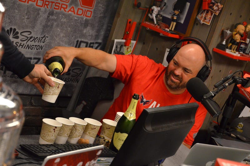 John 'Cakes' Auville pops some champagne for the specialist of occasions