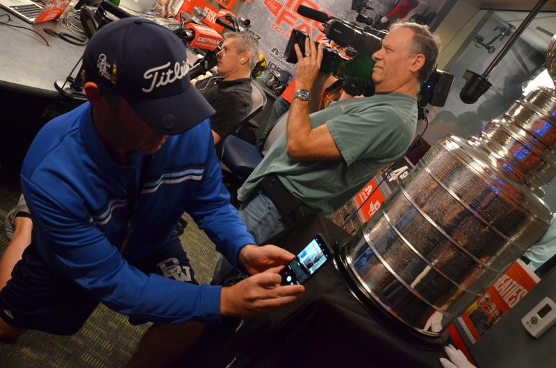 Jason 'Lurch' Bishop snaps a photo of the Stanley Cup