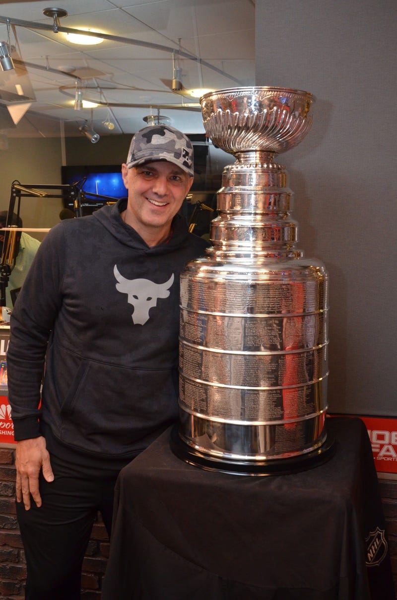 Eric 'EB' Bickel of The Sports Junkies poses with The Stanley Cup