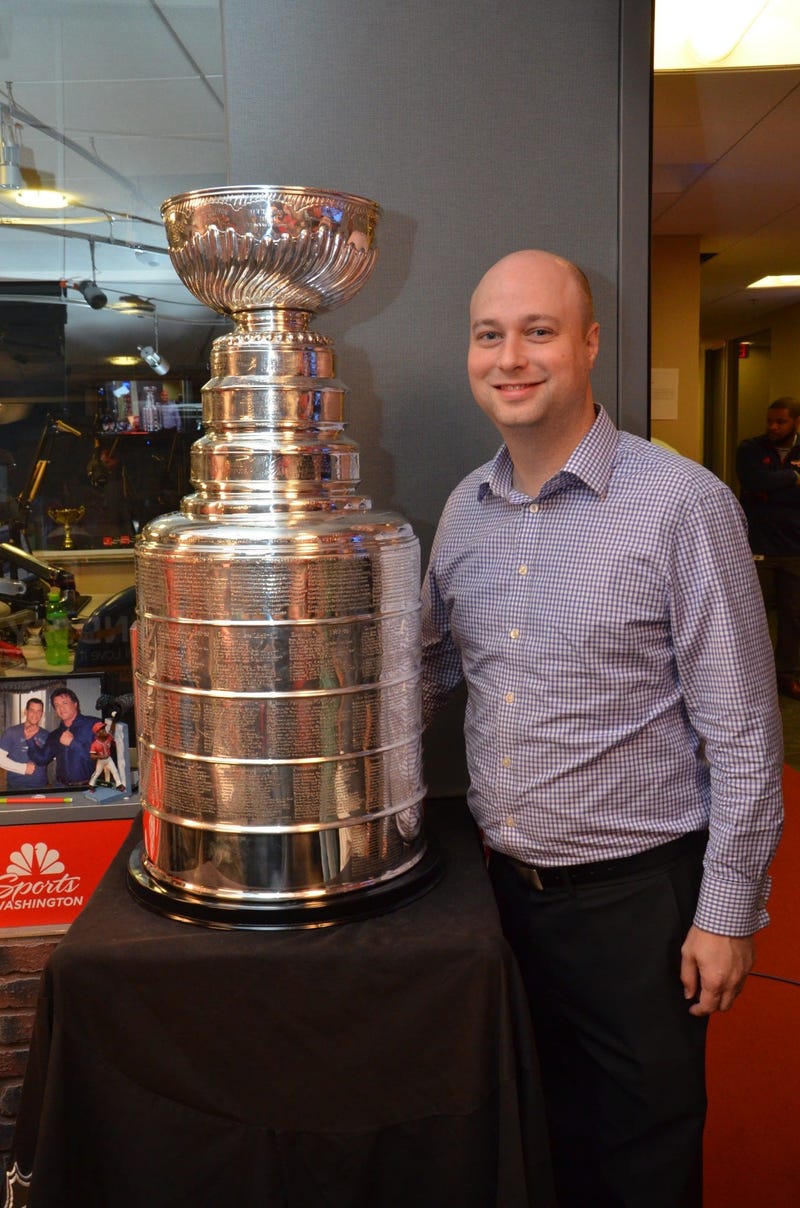 106.7 The Fan program director Chris Kinard poses with the Stanley Cup