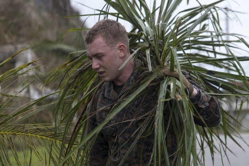 A Marine from the 31st Marine Expeditionary Unit cleans up debris after Typhoon Mangkhut