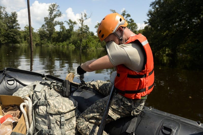 Specialist wipes his eyes as the heat and humidity during a boat patrol in Orange, Texas