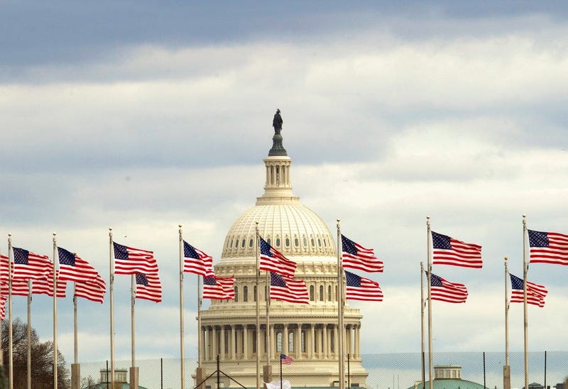 Flags fly in front of the U.S. Capitol in Washington, Tuesday morning, Jan. 1, 2019, as a partial government shutdown stretches into its third week