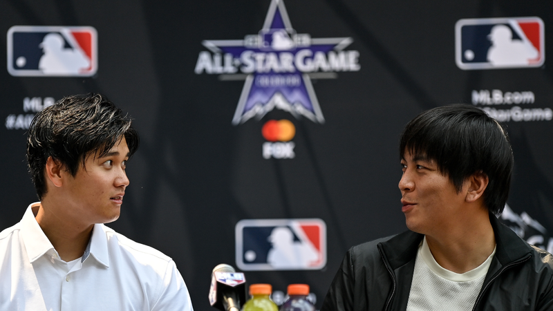 Shohei Ohtani #17 of the Los Angeles Angels and interpreter Ippei Mizuhara (R) speak in a press conference revealing the All Star starting lineups at McGregor Square near Coors Field on July 12, 2021 in Denver, Colorado.