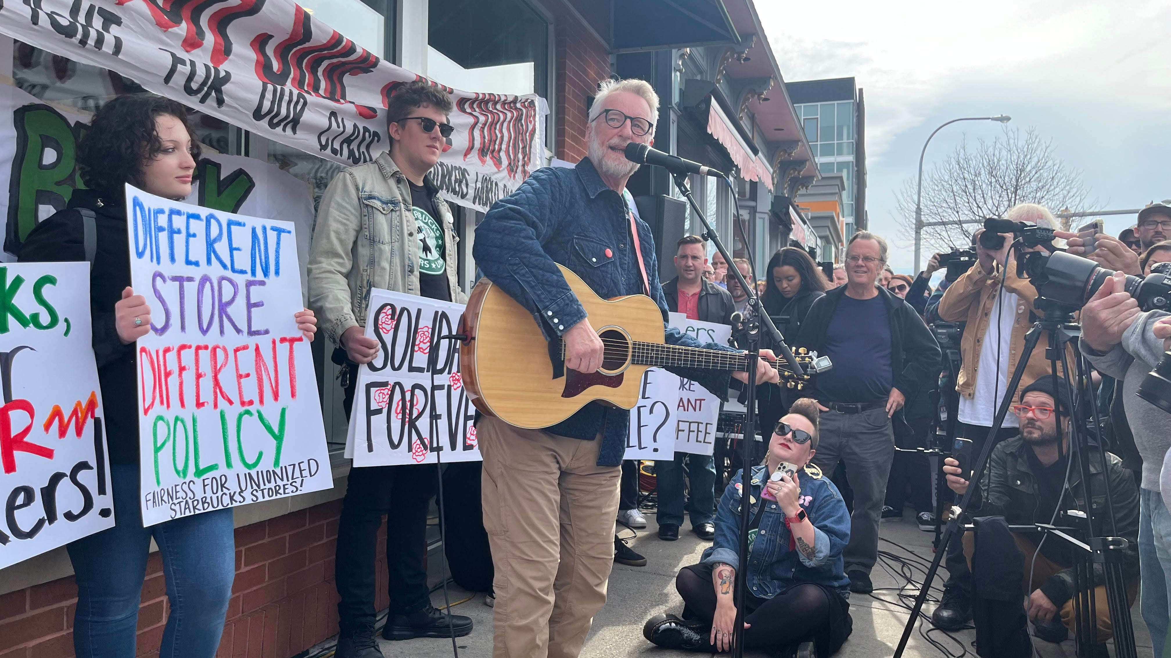 Musician Billy Bragg stands with Starbucks Workers United during picket
