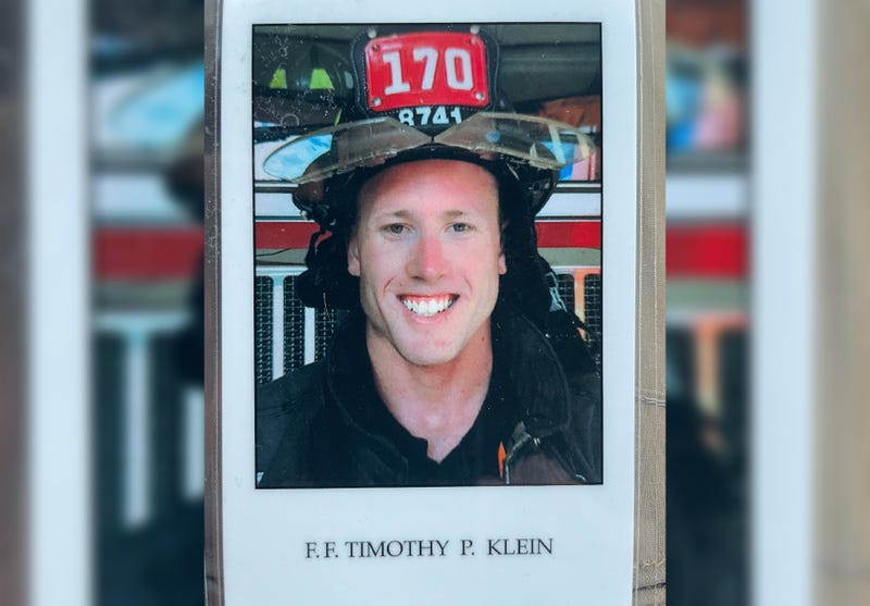 A photo of firefighter Timothy Klein at the funeral Friday