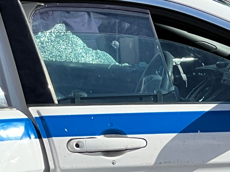 Shattered glass can be seen on the police car that was struck by a bullet on Thursday.
