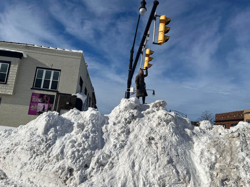 After helping her friend get to work in Buffalo, Erina from Lockport took a pit stop on Hertel Avenue to touch a street light on a really high snow bank. (12/28/2022 Buffalo, N.Y.)