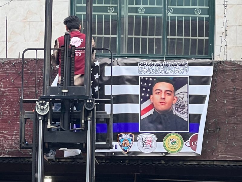 A banner is put up at the Makki Masjid Muslim Community Center on Thursday morning