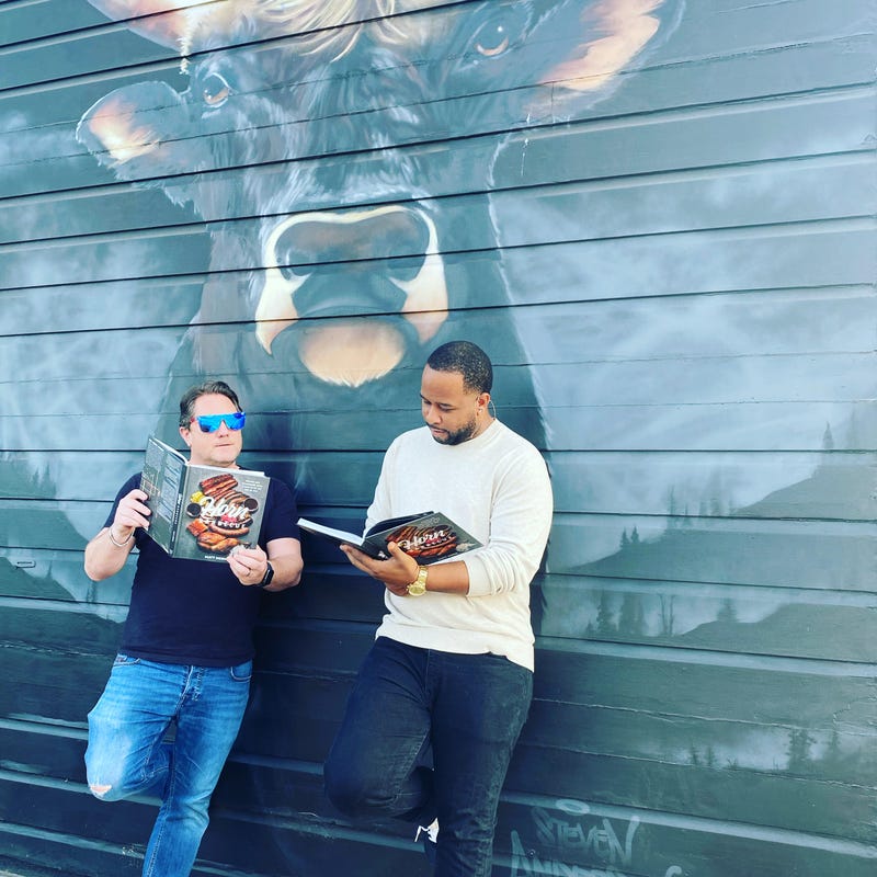 Liam and chef Matt Horn outside Horn Barbecue and reading's Horn's new cook book.