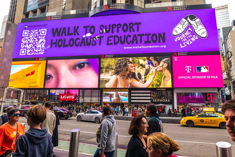 The Mark Schonwetter Holocaust Education Foundation enlisted the help of students at Elon University to design a billboard in Times Square that reads "Walk to Support Holocaust Education"