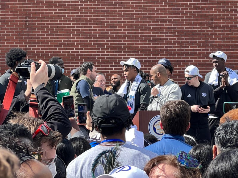 Jersey City Mayor Steven Fulop hands out keys to the city to the Peacock's coaches and players during Friday's parade.