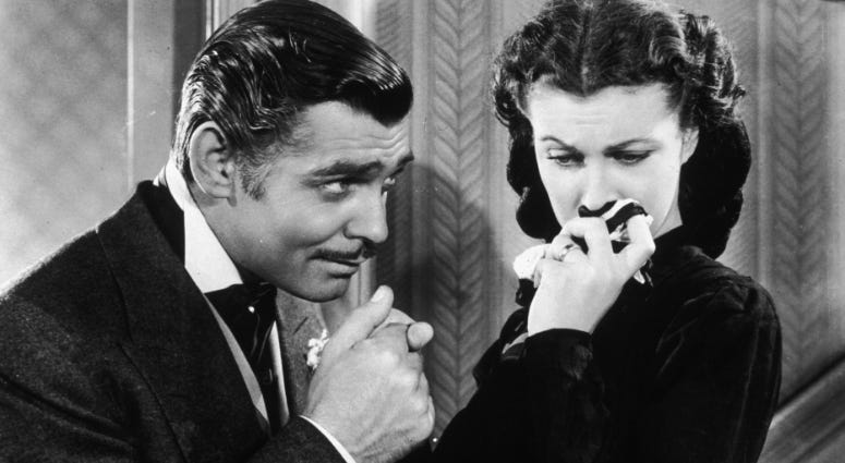 American actor Clark Gable in his role as Rhett Butler kissing the hand of a tearful Scarlett O'Hara, played by Vivien Leigh, in "Gone With The Wind."