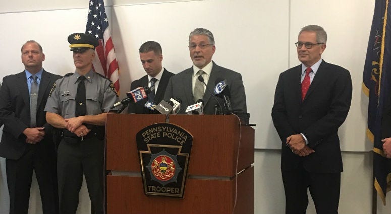 DA Larry Krasner and Pa. State Police at a press conference.