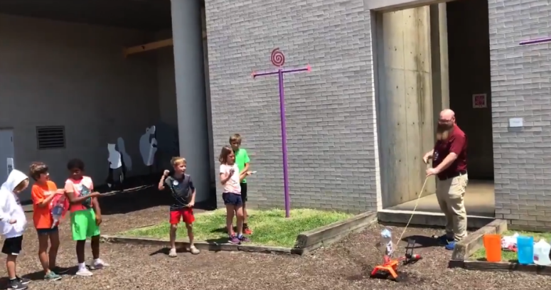 Kids participating in a science camp at the Franklin Institute celebrated the launch of Apollo 11 by making model rockets and then testing them out. 