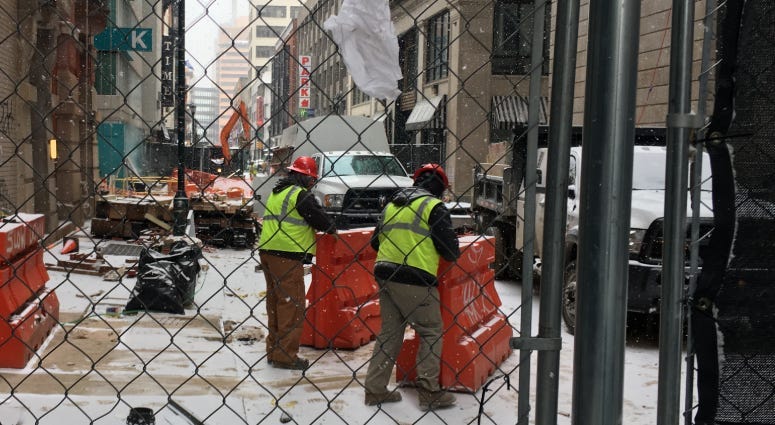 Work crews continue to repair damage done by a water main break in July on Sansom Street near Juniper.
