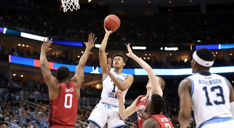 Rhode Island's Jeff Dowtin takes a shot against Oklahoma's Christian James on March 16, 2018, in the first round of the NCAA tournament at PPG Paints Arena in Pittsburgh.