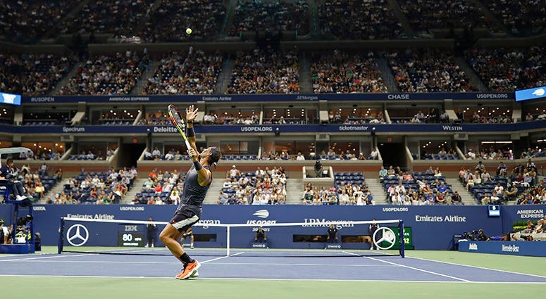 Aug 27, 2018; New York, NY, USA; Rafael Nadal of Spain serves against David Ferrer of Spain (far court) in the first round on day one of the 2018 U.S. Open tennis tournament at USTA Billie Jean King National Tennis Center. Mandatory Credit: Geoff Burke-US
