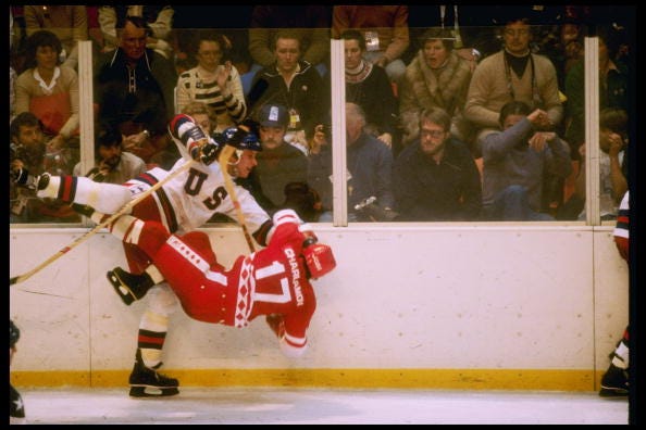 USA's Mike Ramsey pummels into Soviet Union's Valeri Kharlamov. 