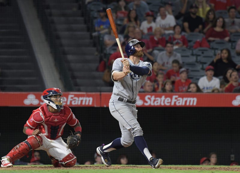 Jul 14, 2017; Anaheim, CA, USA; Tampa Bay Rays second baseman Brad Miller (13) follows through on a run-scoring single in the 10th inning as Los Angeles Angels catcher Martin Maldonado (12) watches during a MLB baseball game at Angel Stadium of Anaheim. 