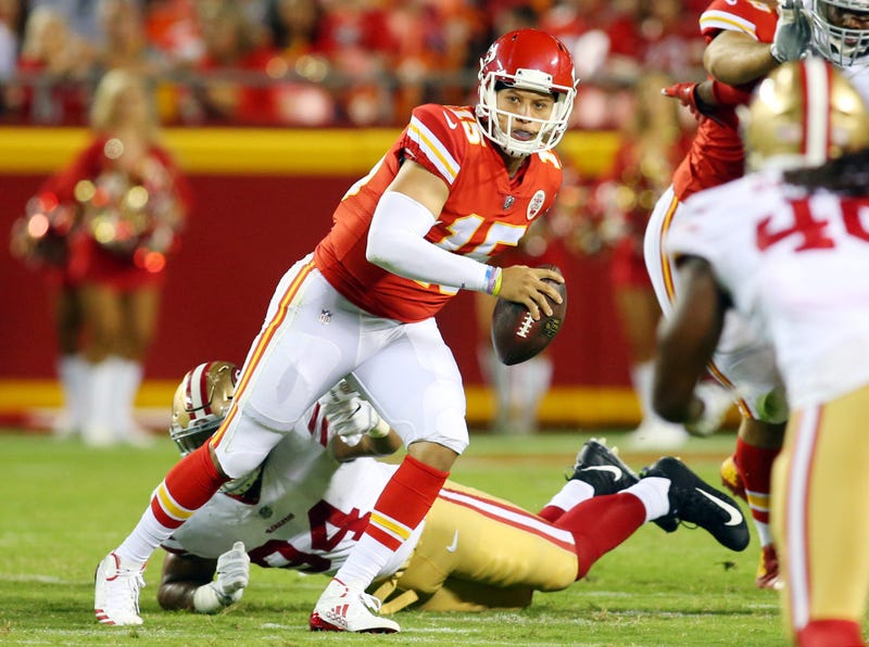 Kansas City Chiefs quarterback Patrick Mahomes II (15) evades San Francisco 49ers defensive lineman Solomon Thomas (94) in the second half at Arrowhead Stadium.
