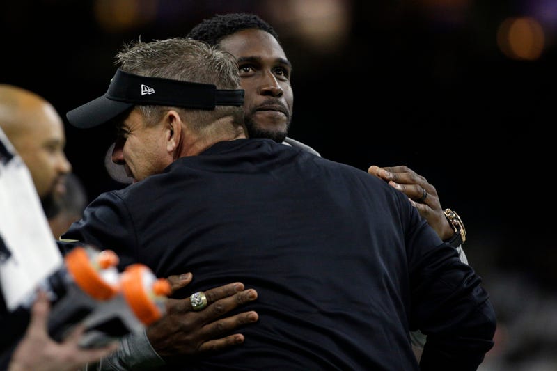 New Orleans Saints former running back Reggie Bush (facing camera) is hugged by New Orleans Saints head coach Sean Payton before the NFC Wild Card playoff football game against the Carolina Panthers at Mercedes-Benz Superdome.