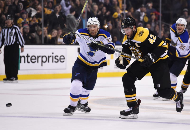 Boston Bruins right wing David Backes (42) skates after a loose puck ahead of St. Louis Blues left wing Jaden Schwartz