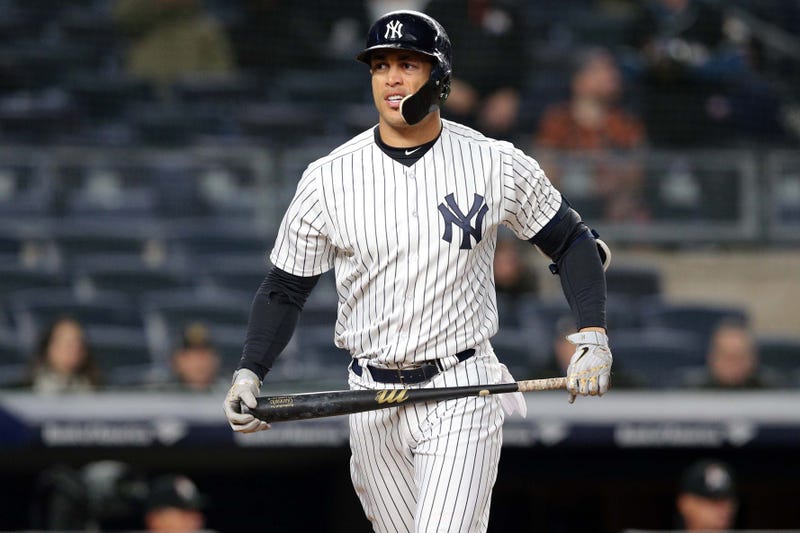 Giancarlo Stanton reacts after striking out against the Miami Marlins during the eighth inning at Yankee Stadium