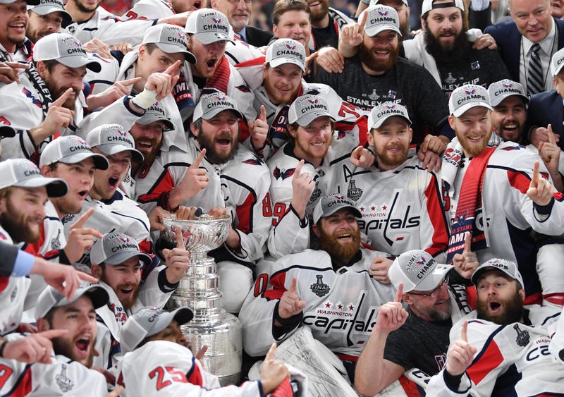 Washington Capitals players pose for a team photo with the Stanley Cup