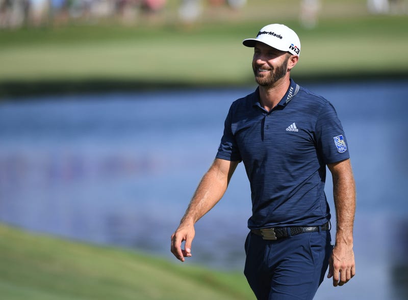 Dustin Johnson walks the green after hitting an eagle from 171 yards on the 18th hole