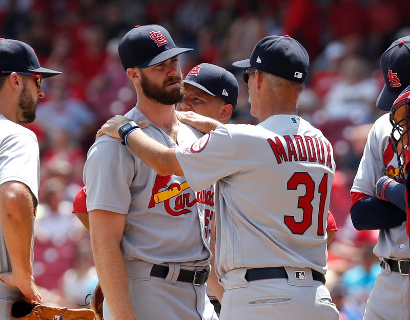 St. Louis Cardinals pitching coach Mike Maddux (31) talks with relief pitcher John Gant