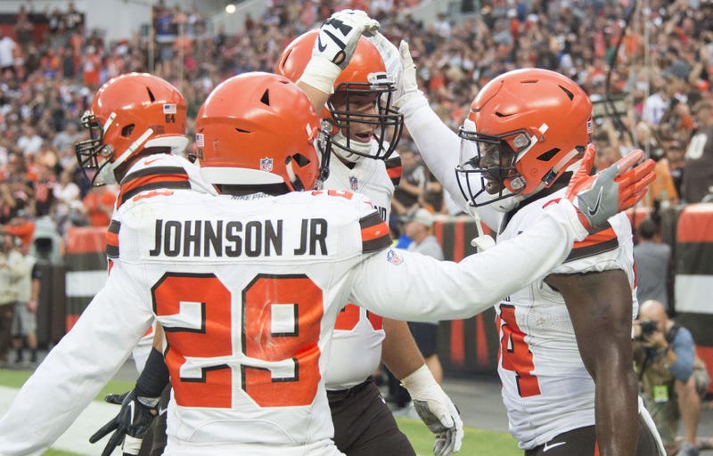 Cleveland Browns running back Carlos Hyde, right, celebrates his first quarter touchdown with running back Duke Johnson (29) and center JC Tretter (64) against the Buffalo Bills at FirstEnergy Stadium.