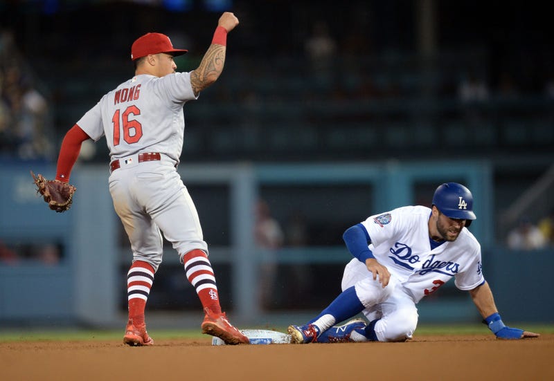Los Angeles Dodgers second baseman Chris Taylor (3) is out at second on a double play as St. Louis Cardinals second baseman Kolten Wong