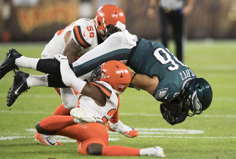 Cleveland Browns cornerback Denzel Ward (21) tackles Philadelphia Eagles tight end Zach Ertz (86) during the first quarter at FirstEnergy Stadium. Ward was injured on the play.