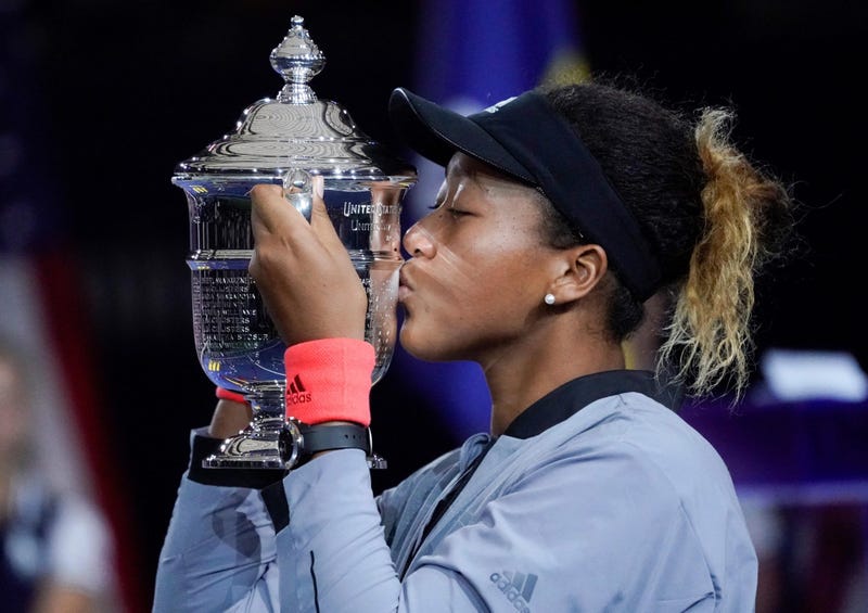 Naomi Osaka kisses the U.S. Open trophy after beating Serena Williams in the U.S. Open women's final on Sept. 9, 2018, at USTA Billie Jean King National Tennis Center