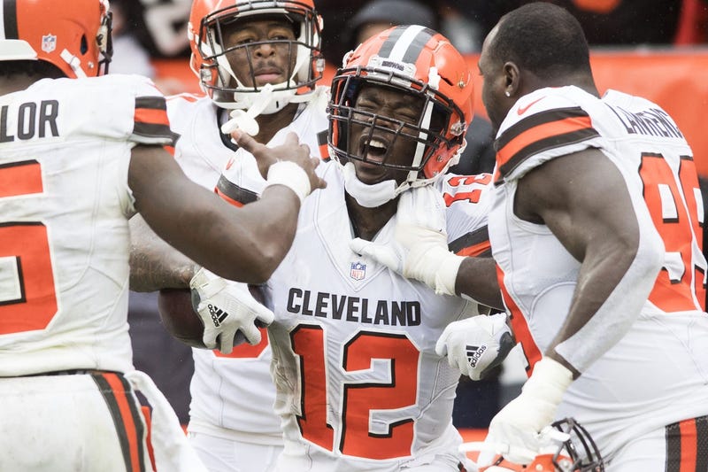 Cleveland Browns wide receiver Josh Gordon (12) celebrates with quarterback Tyrod Taylor (5) and defensive tackle Devaroe Lawrence (99) after catching a touchdown during the fourth quarter at FirstEnergy Stadium.
