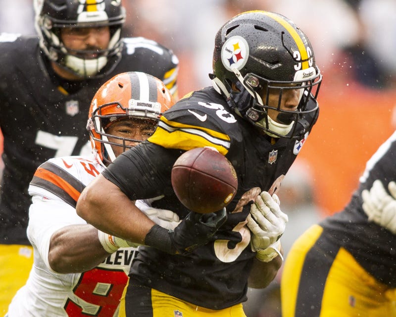 Cleveland Browns defensive end Myles Garrett (95) forces a fumble by Pittsburgh Steelers running back James Conner (30) during the fourth quarter at FirstEnergy Stadium.