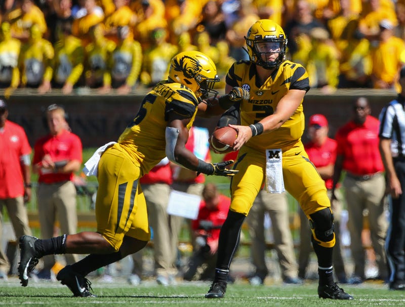 Missouri Tigers quarterback Drew Lock (3) hands off to running back Damarea Crockett