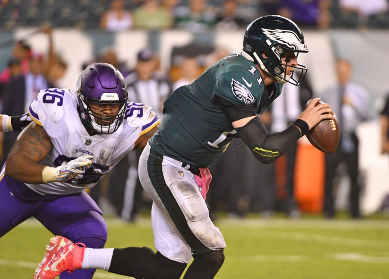 Philadelphia Eagles quarterback Carson Wentz (11) scrambles away from Minnesota Vikings defensive tackle Tom Johnson (96) during the fourth quarter at Lincoln Financial Field.