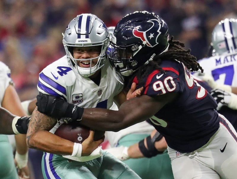 Oct 7, 2018; Houston, TX, USA; Dallas Cowboys quarterback Dak Prescott (4) evades the tackle of Houston Texans linebacker Jadeveon Clowney (90) during the second half at NRG Stadium. 