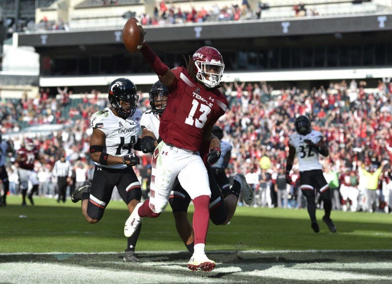 Temple Owls wide receiver Isaiah Wright (13) celebrates in the end zone after scoring a touchdown past Cincinnati Bearcats cornerback Cameron Jefferies (14) and safety Darrick Forrest (5) during overtime.