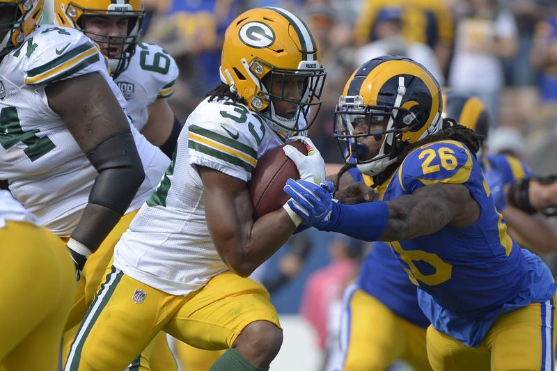 Green Bay Packers running back Aaron Jones (33) is defended by Los Angeles Rams linebacker Mark Barron (26)
