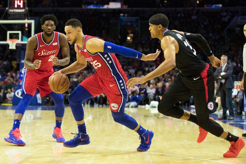 Philadelphia 76ers guard Ben Simmons dribbles past LA Clippers forward Tobias Harris in front of center Joel Embiid  during the third quarter at Wells Fargo Center on Nov 1, 2018. 