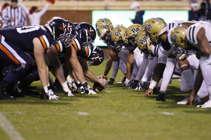 The Virginia Cavaliers offense lines up against the Pittsburgh Panthers defense in the first quarter at Scott Stadium.